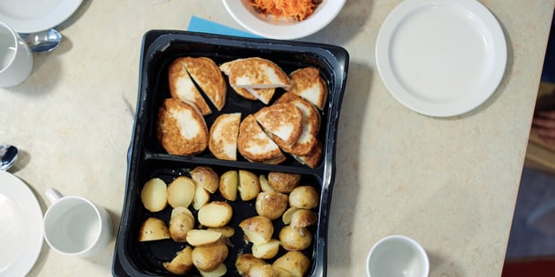 Barnehage, Varmt måltid, dekket for måltid, tallerkener, kopper, skjeer, Fiskekaker og stekte poteter. Illustrasjonsfoto