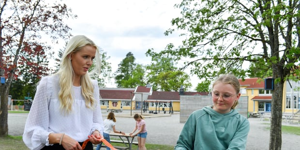 Foto av kvinnelig lærer med elev utendørs