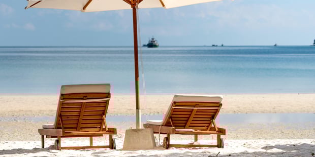 Foto av to strandstoler på en strand, utsikt over havet
