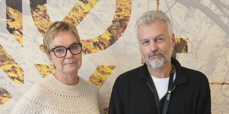 Bilde av Tore Hølmo og Gry Rollag Føsker stående foran en vegg. De ser rett inn i kamera, smiler ikke. FOTO: Tone Stangnes Gjerstad