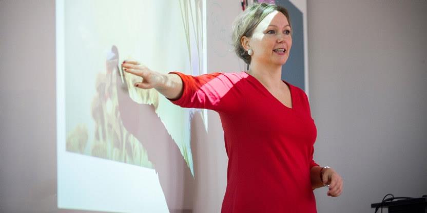 Kvinne peker og presenterer power point